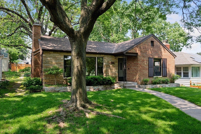 4932 Cedar Ave S, Minneapolis, MN 55417 - view of front of home with a chimney, brick siding, and roof with shingles
