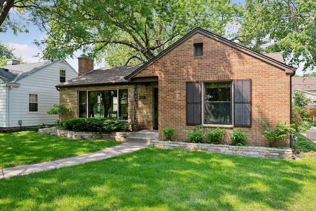 4932 Cedar Ave S, Minneapolis, MN 55417 - view of front facade with brick siding, a front yard, a chimney, and a shingled roof