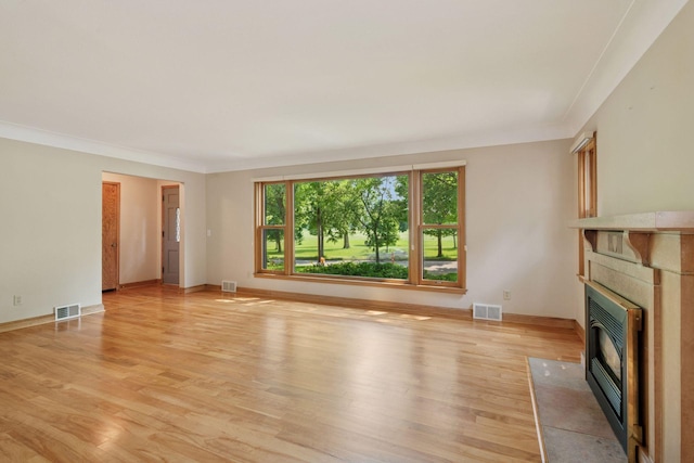 4932 Cedar Ave S, Minneapolis, MN 55417 - unfurnished living room featuring a fireplace with flush hearth, light wood-style floors, and crown molding