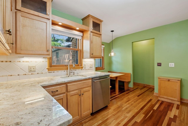4932 Cedar Ave S, Minneapolis, MN 55417 - kitchen featuring stainless steel dishwasher, light wood-style floors, backsplash, and hanging light fixtures