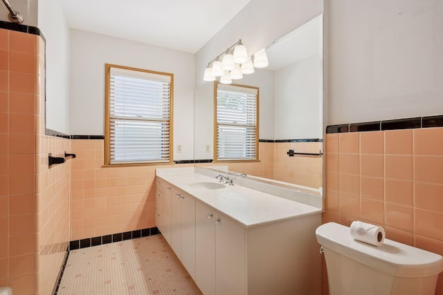 4932 Cedar Ave S, Minneapolis, MN 55417 - bathroom with tile walls, vanity, and a wainscoted wall
