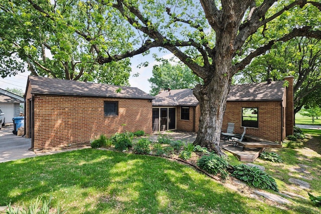 4932 Cedar Ave S, Minneapolis, MN 55417 - back of house with brick siding, a lawn, a patio area, and a chimney