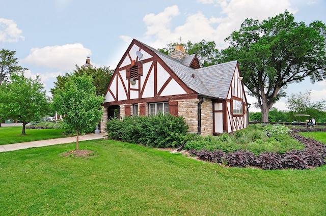 4932 Cedar Ave S, Minneapolis, MN 55417 - view of front facade with stone siding, a front lawn, and a chimney