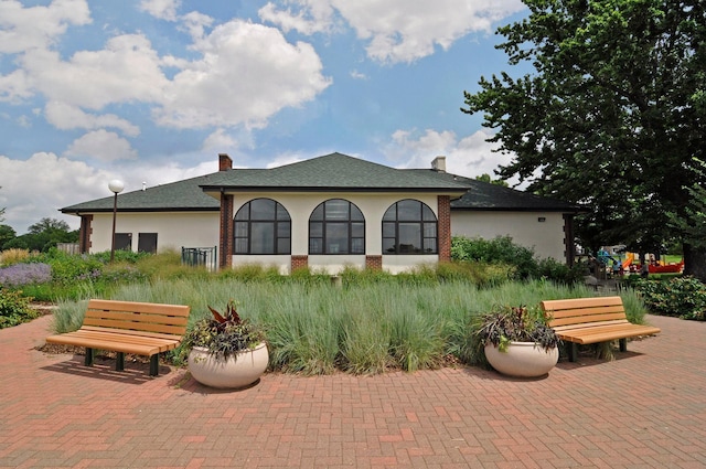 4932 Cedar Ave S, Minneapolis, MN 55417 - view of home's exterior featuring stucco siding and a chimney