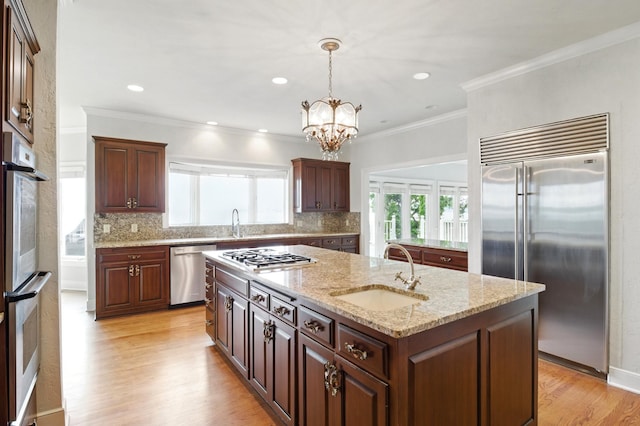2645 Arcola Ln, Minnetonka Beach, MN 55391 - kitchen featuring stainless steel appliances, a kitchen island with sink, healthy amount of natural light, a chandelier, and ornamental molding