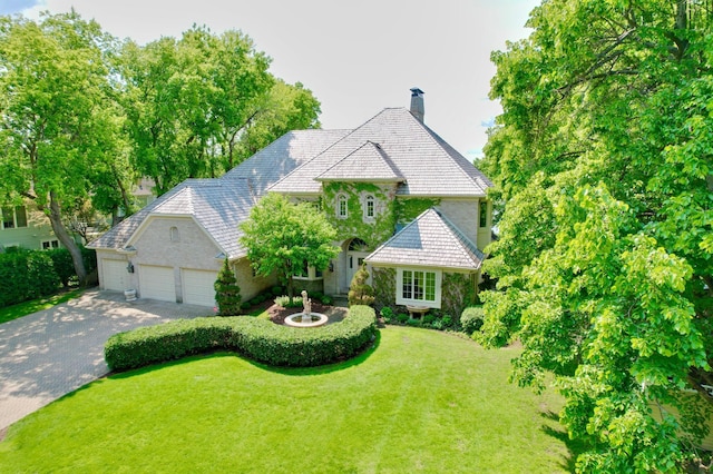 2645 Arcola Ln, Minnetonka Beach, MN 55391 - view of front of house with a chimney, driveway, a front lawn, and an attached garage