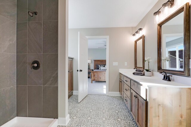 10014 177th Ave NW, Elk River, MN 55330 - ensuite bathroom with double vanity, tiled shower, baseboards, and ceiling fan