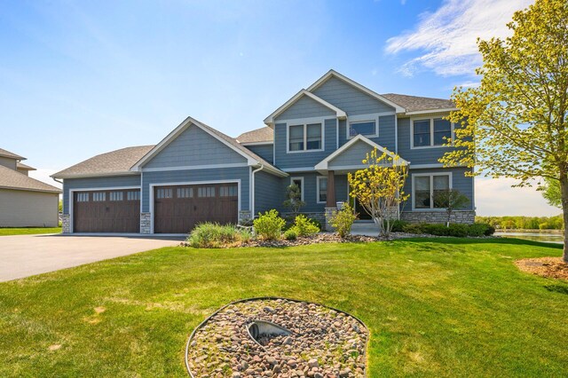 26042 Sunset Dr, Chisago City, MN 55013 - craftsman house featuring stone siding, driveway, an attached garage, and a front yard