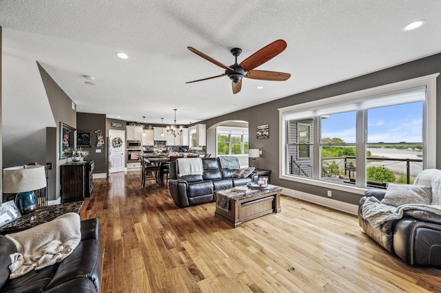 26042 Sunset Dr, Chisago City, MN 55013 - living area with a ceiling fan, hardwood / wood-style floors, a chandelier, recessed lighting, and baseboards