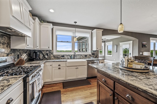 26042 Sunset Dr, Chisago City, MN 55013 - kitchen with appliances with stainless steel finishes, custom range hood, a sink, light stone countertops, and recessed lighting
