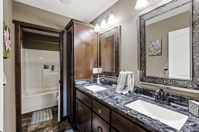 26042 Sunset Dr, Chisago City, MN 55013 - bathroom with double vanity, toilet, shower / tub combination, and a textured ceiling