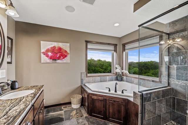 26042 Sunset Dr, Chisago City, MN 55013 - full bath featuring vanity, tiled shower, a garden tub, stone tile flooring, and recessed lighting