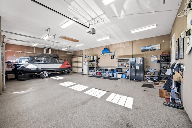 26042 Sunset Dr, Chisago City, MN 55013 - garage with black fridge with ice dispenser and a garage door opener