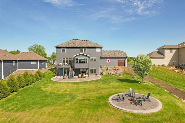 26042 Sunset Dr, Chisago City, MN 55013 - rear view of house featuring a patio area, a fire pit, stairs, and a lawn