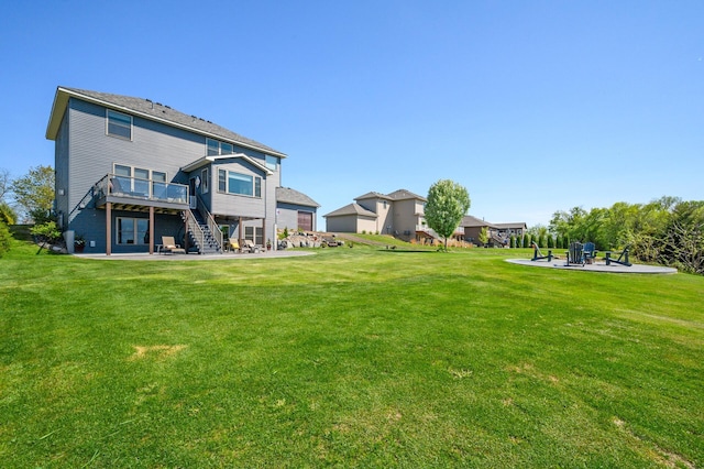 26042 Sunset Dr, Chisago City, MN 55013 - rear view of house with a patio area, stairs, a wooden deck, and a yard