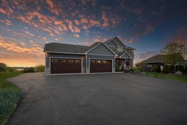 26042 Sunset Dr, Chisago City, MN 55013 - view of front of property with asphalt driveway, an attached garage, and stone siding