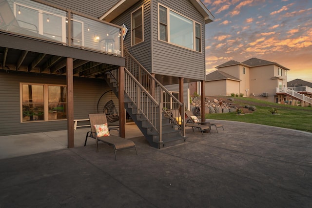 26042 Sunset Dr, Chisago City, MN 55013 - patio terrace at dusk with a patio area, stairs, and a yard