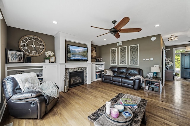 26042 Sunset Dr, Chisago City, MN 55013 - living area with a ceiling fan, a high end fireplace, wood finished floors, and recessed lighting