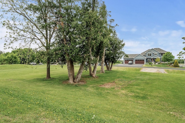 26042 Sunset Dr, Chisago City, MN 55013 - view of green lawn with an attached garage and asphalt driveway
