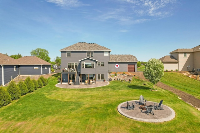 26042 Sunset Dr, Chisago City, MN 55013 - back of property with a fire pit, a patio, stairway, and a yard