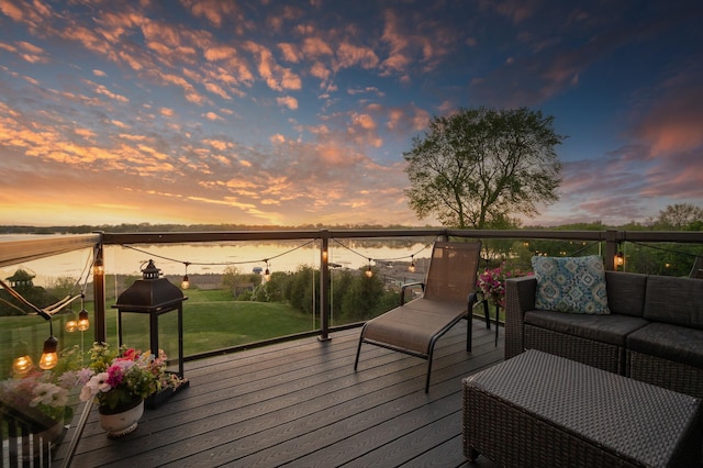 26042 Sunset Dr, Chisago City, MN 55013 - deck at dusk featuring an outdoor living space and a lawn