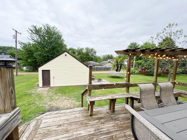 408 Lafayette Ave, Fulda, MN 56131 - wooden deck featuring a trampoline, a yard, and an outdoor structure