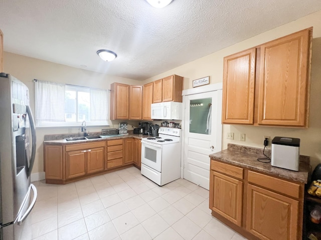 408 Lafayette Ave, Fulda, MN 56131 - kitchen featuring white appliances, a sink, dark countertops, a textured ceiling, and light tile patterned flooring
