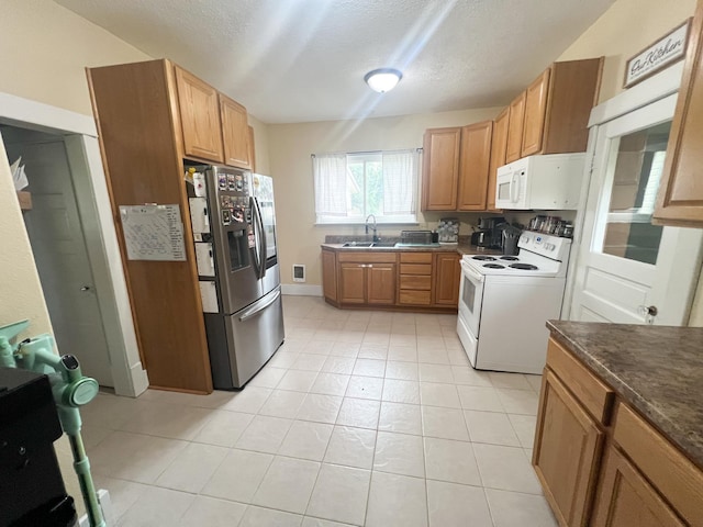 408 Lafayette Ave, Fulda, MN 56131 - kitchen featuring white appliances, dark countertops, a sink, a textured ceiling, and light tile patterned floors