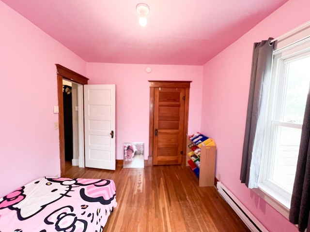 408 Lafayette Ave, Fulda, MN 56131 - bedroom featuring multiple windows, wood finished floors, and baseboard heating