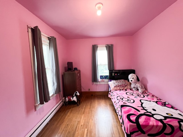 408 Lafayette Ave, Fulda, MN 56131 - bedroom featuring wood finished floors and a baseboard heating unit