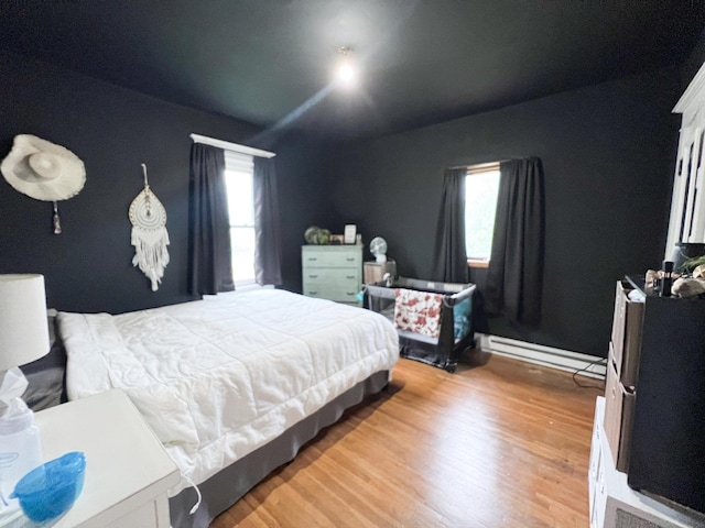 408 Lafayette Ave, Fulda, MN 56131 - bedroom with multiple windows, light wood finished floors, and baseboard heating