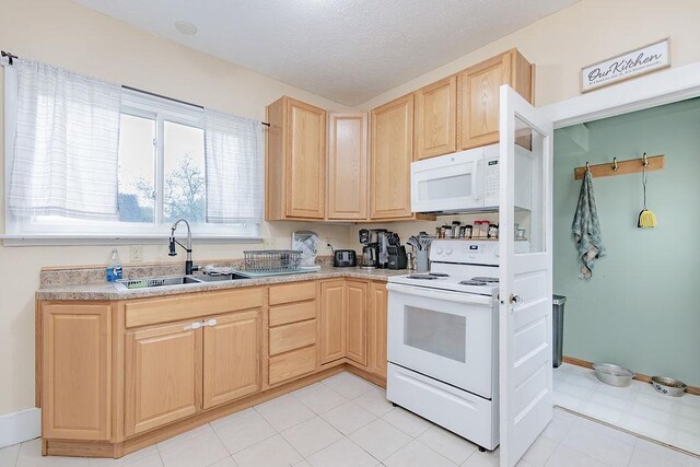 408 Lafayette Ave, Fulda, MN 56131 - kitchen featuring white appliances, light brown cabinetry, a sink, light countertops, and a textured ceiling