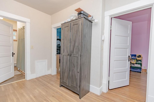408 Lafayette Ave, Fulda, MN 56131 - corridor featuring light wood-style floors, baseboards, and a baseboard radiator