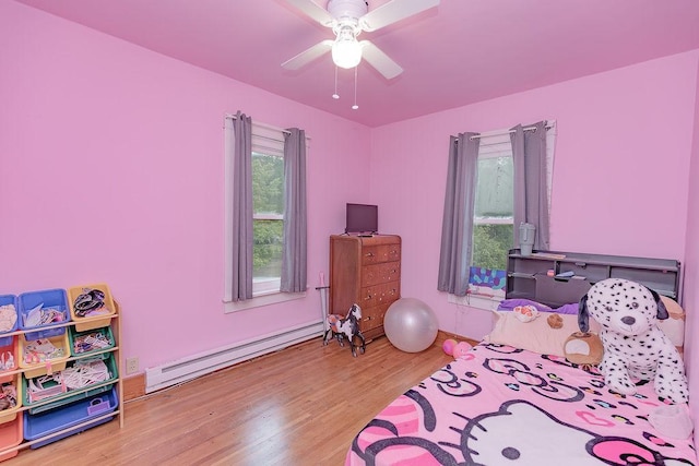 408 Lafayette Ave, Fulda, MN 56131 - bedroom featuring a baseboard radiator, wood finished floors, and a ceiling fan