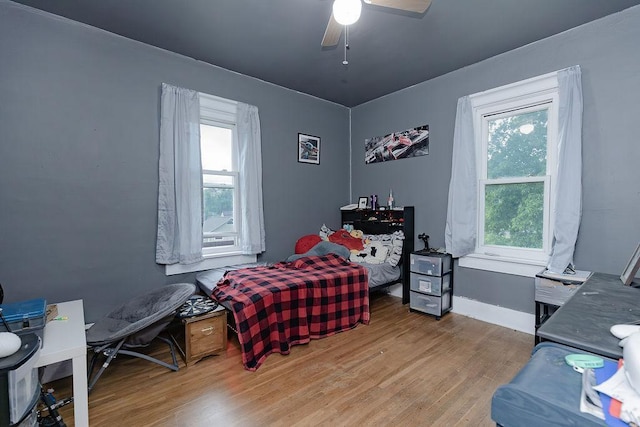 408 Lafayette Ave, Fulda, MN 56131 - bedroom with wood finished floors, multiple windows, ceiling fan, and baseboards