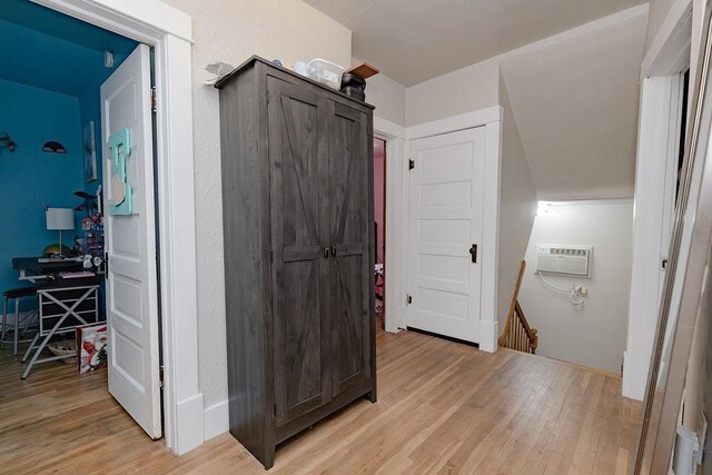408 Lafayette Ave, Fulda, MN 56131 - hallway with light wood finished floors, an AC wall unit, and an upstairs landing