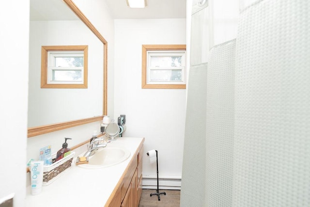 408 Lafayette Ave, Fulda, MN 56131 - full bathroom featuring baseboard heating, vanity, and a shower with shower curtain