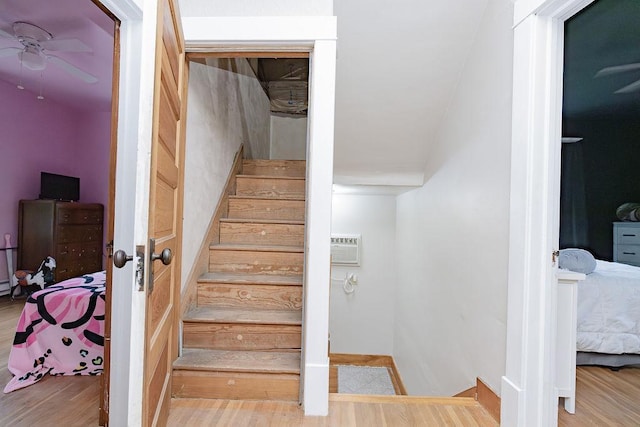408 Lafayette Ave, Fulda, MN 56131 - stairway with ceiling fan, wood finished floors, and a wall mounted air conditioner
