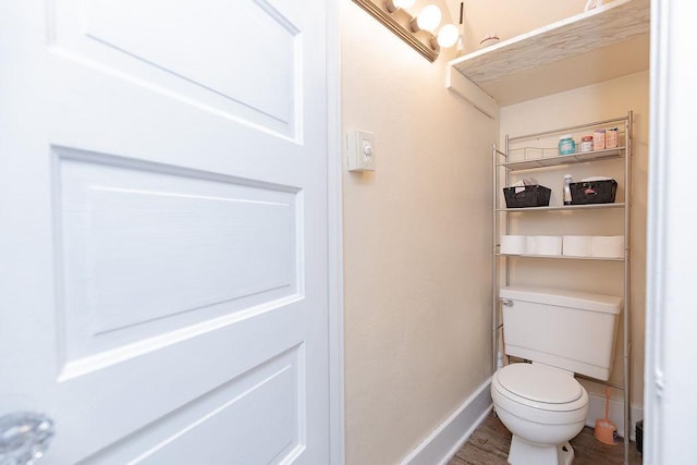 408 Lafayette Ave, Fulda, MN 56131 - bathroom featuring baseboards, wood finished floors, and toilet