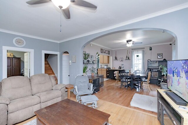 408 Lafayette Ave, Fulda, MN 56131 - living area featuring a ceiling fan, arched walkways, light wood-style flooring, crown molding, and stairs