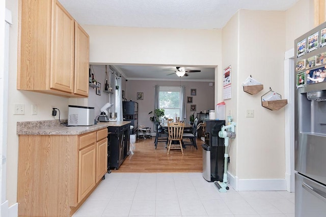 408 Lafayette Ave, Fulda, MN 56131 - kitchen featuring light brown cabinets, stainless steel fridge with ice dispenser, a ceiling fan, light countertops, and baseboards