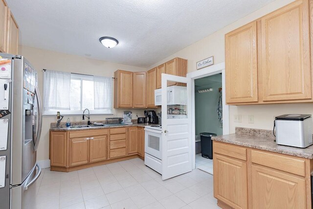 408 Lafayette Ave, Fulda, MN 56131 - kitchen featuring white appliances, light brown cabinets, a sink, light countertops, and a textured ceiling
