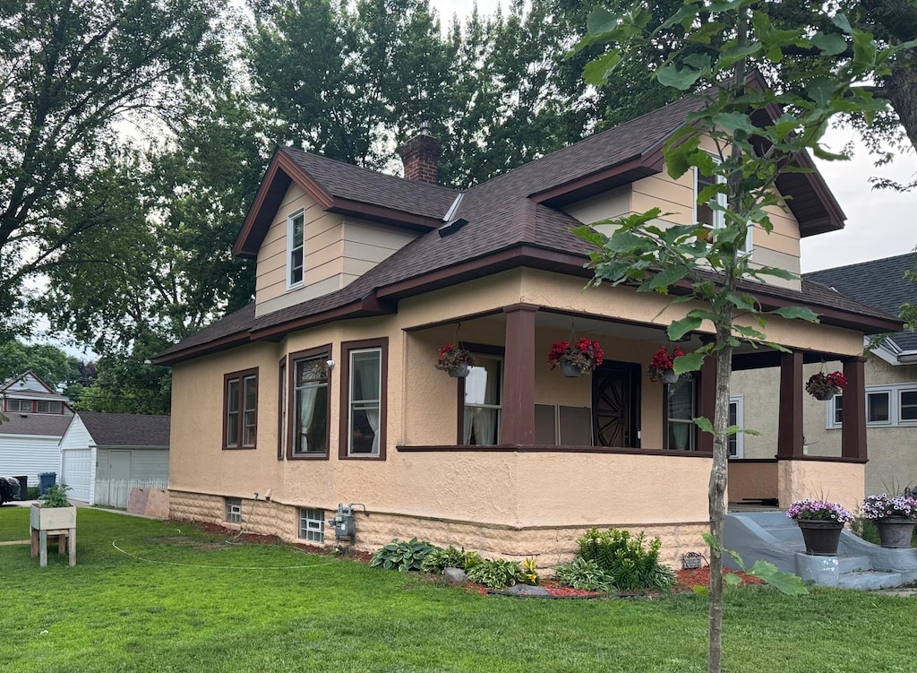 2852 36th Ave S, Minneapolis, MN 55406 - view of side of home featuring a yard, a shingled roof, and a chimney
