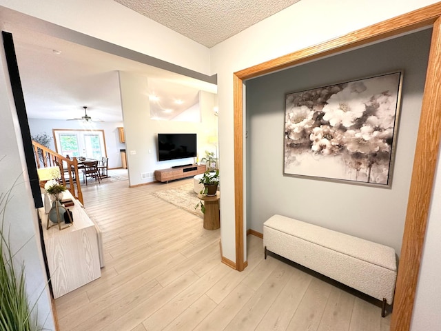 12224 Radisson Rd NE, Blaine, MN 55449 - corridor with baseboards, light wood finished floors, and a textured ceiling