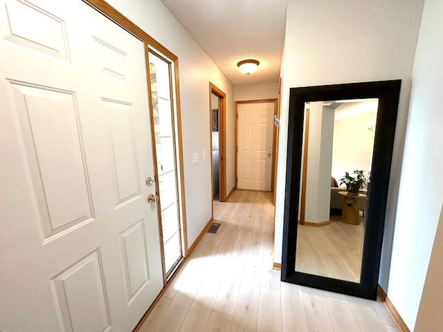 12224 Radisson Rd NE, Blaine, MN 55449 - corridor with baseboards and light wood finished floors
