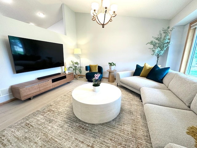 12224 Radisson Rd NE, Blaine, MN 55449 - living area with wood finished floors, a chandelier, vaulted ceiling, and baseboards