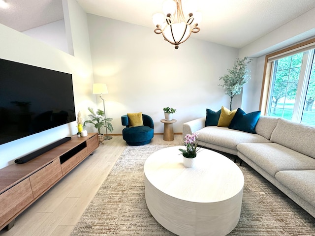 12224 Radisson Rd NE, Blaine, MN 55449 - living area featuring wood finished floors, a chandelier, and lofted ceiling