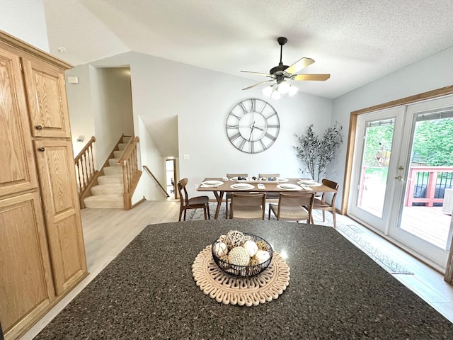 12224 Radisson Rd NE, Blaine, MN 55449 - dining area with light wood-style flooring, lofted ceiling, a ceiling fan, stairway, and a textured ceiling
