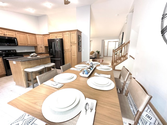 12224 Radisson Rd NE, Blaine, MN 55449 - dining room with stairway and high vaulted ceiling