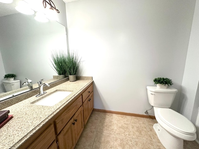 12224 Radisson Rd NE, Blaine, MN 55449 - bathroom featuring toilet, baseboards, vanity, and tile patterned flooring